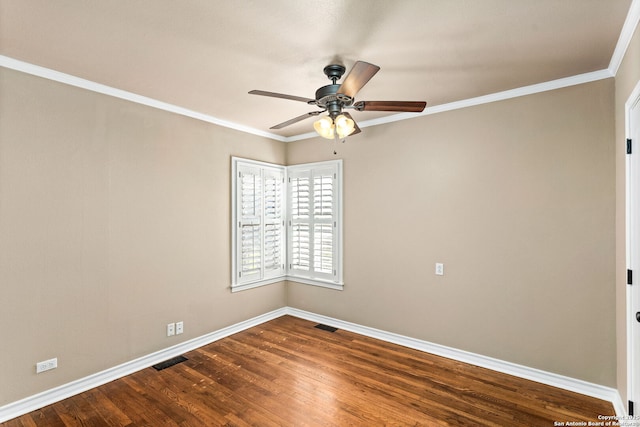 empty room featuring ceiling fan, visible vents, baseboards, dark wood-style floors, and crown molding