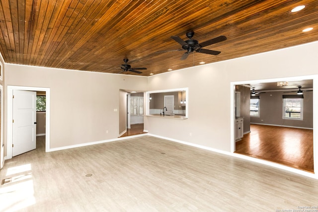 unfurnished living room with recessed lighting, wood finished floors, wood ceiling, and baseboards