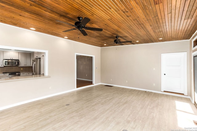 unfurnished room with light wood-style floors, recessed lighting, and baseboards