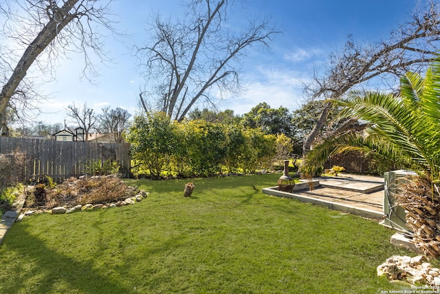 view of yard with fence and a patio