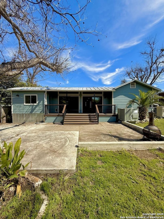 view of front of property with covered porch and central AC