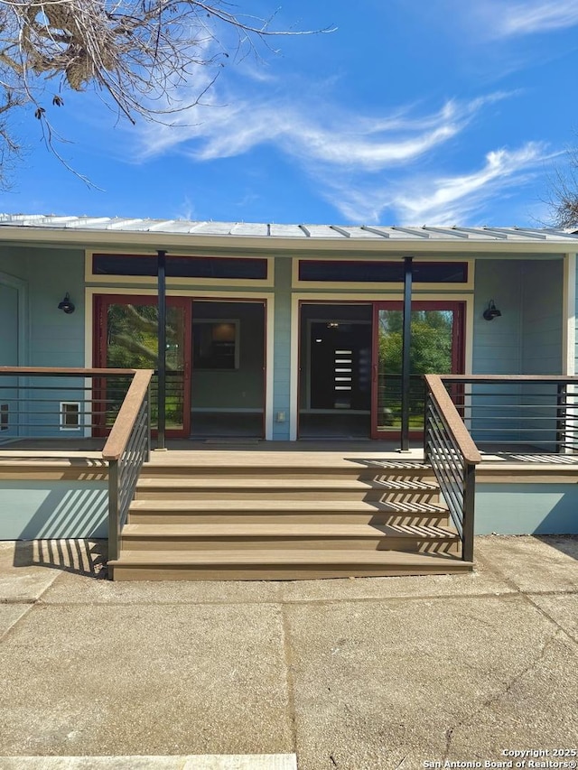 view of exterior entry featuring covered porch