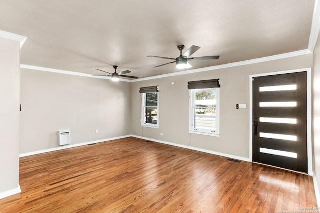 entryway with crown molding, visible vents, and wood finished floors