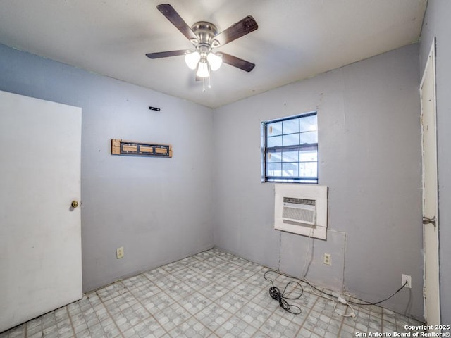 unfurnished room with a wall unit AC, a ceiling fan, and tile patterned floors