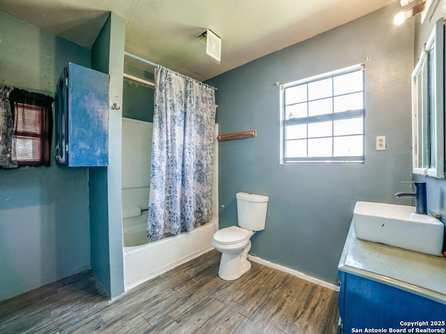 full bathroom with shower / bathtub combination with curtain, toilet, vanity, wood finished floors, and baseboards