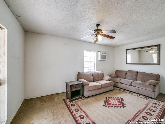 living area featuring ceiling fan, a textured ceiling, an AC wall unit, and light colored carpet