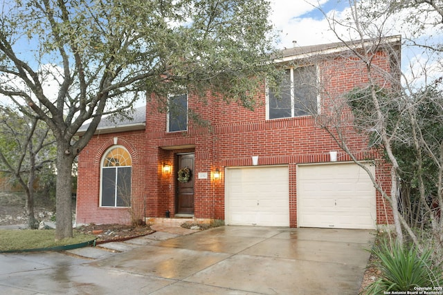 traditional home featuring driveway, brick siding, and an attached garage