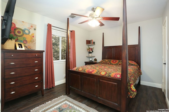 bedroom with dark wood-style flooring, visible vents, and baseboards