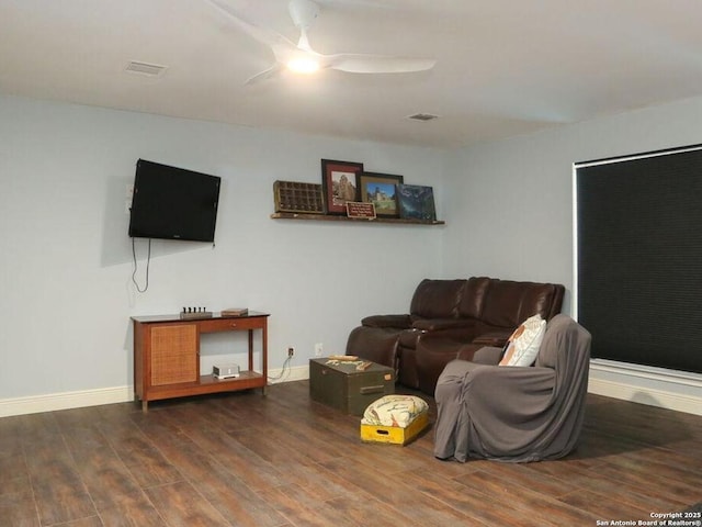 living room with visible vents, wood finished floors, a ceiling fan, and baseboards