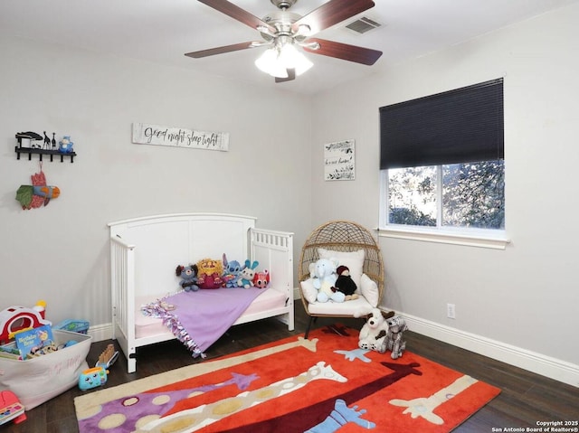 bedroom featuring ceiling fan, wood finished floors, visible vents, and baseboards