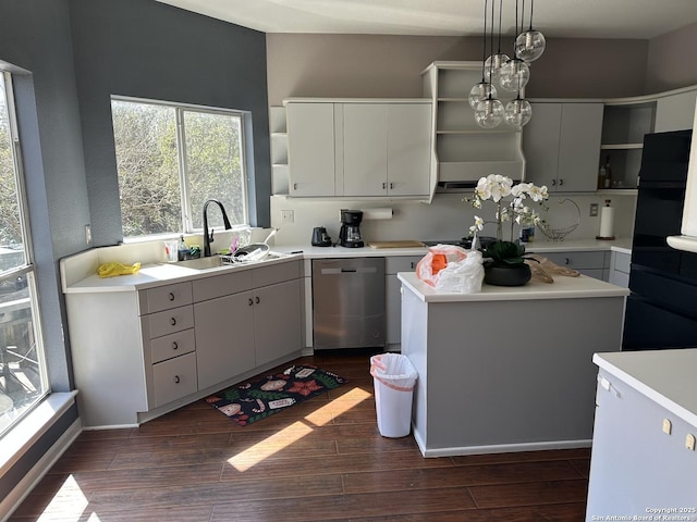 kitchen with dark wood-style flooring, open shelves, light countertops, a sink, and dishwasher