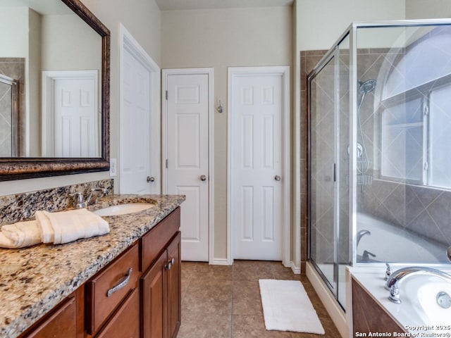 full bathroom with tile patterned floors, a garden tub, vanity, and a shower stall