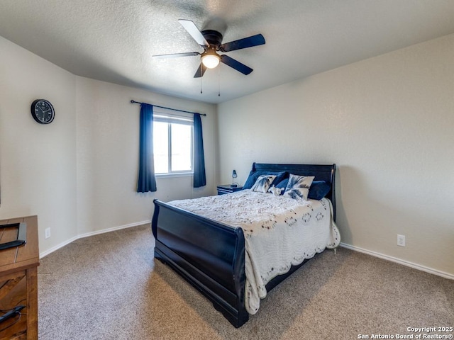 carpeted bedroom with ceiling fan, a textured ceiling, and baseboards