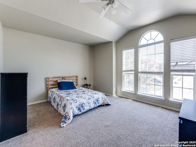 bedroom with carpet floors, a textured ceiling, baseboards, and vaulted ceiling