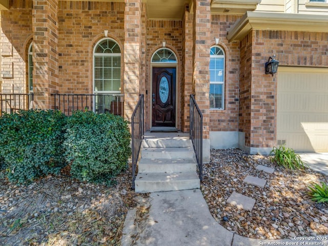 view of exterior entry featuring brick siding