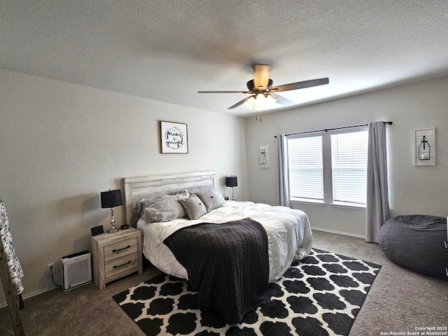 carpeted bedroom with a ceiling fan, baseboards, and a textured ceiling