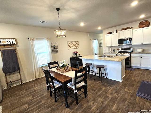 dining space featuring baseboards, visible vents, dark wood-style flooring, a textured ceiling, and recessed lighting