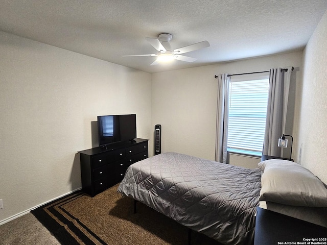 bedroom with a textured ceiling, carpet, a ceiling fan, and baseboards