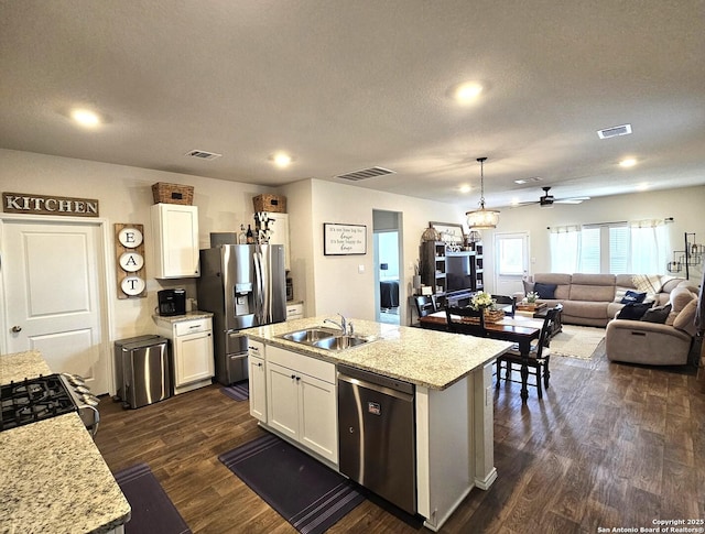 kitchen featuring dark wood-style floors, visible vents, stainless steel appliances, and a sink