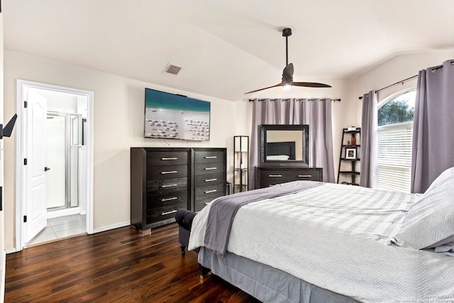 bedroom with baseboards, visible vents, connected bathroom, dark wood finished floors, and vaulted ceiling