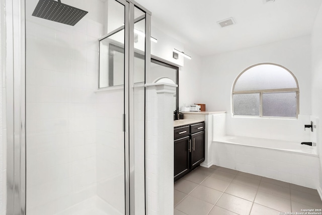 bathroom with a garden tub, visible vents, a shower stall, vanity, and tile patterned flooring