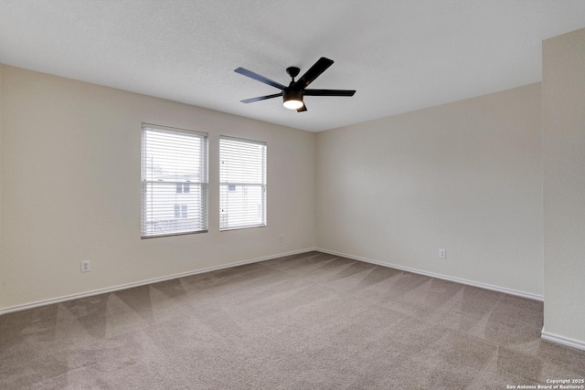 unfurnished room featuring carpet, baseboards, ceiling fan, and a textured ceiling