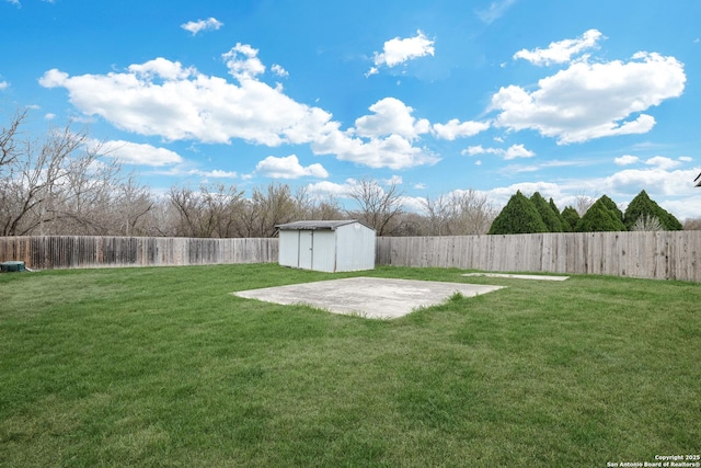 view of yard with a fenced backyard, an outdoor structure, a patio, and a shed