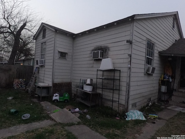 view of property exterior with cooling unit and an AC wall unit