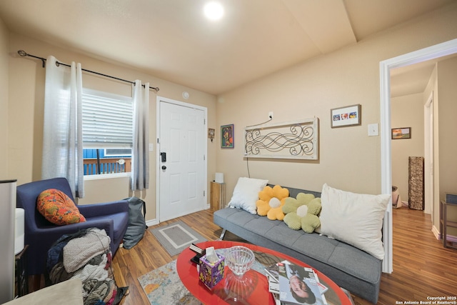 living room featuring baseboards and wood finished floors