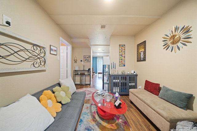 living room featuring visible vents and wood finished floors