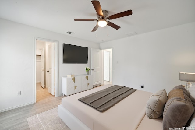 bedroom featuring a ceiling fan, baseboards, visible vents, and light wood finished floors