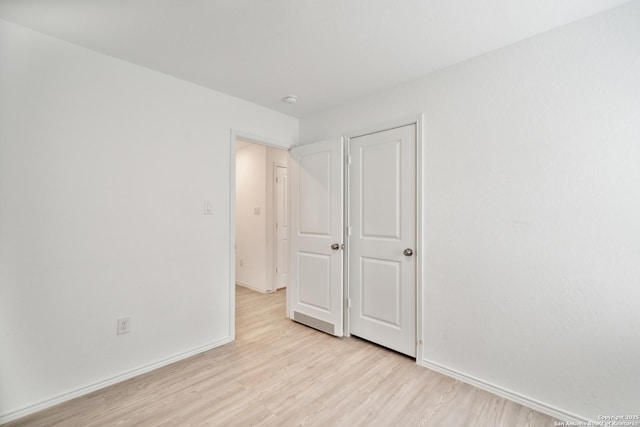 unfurnished bedroom featuring baseboards and light wood-style floors