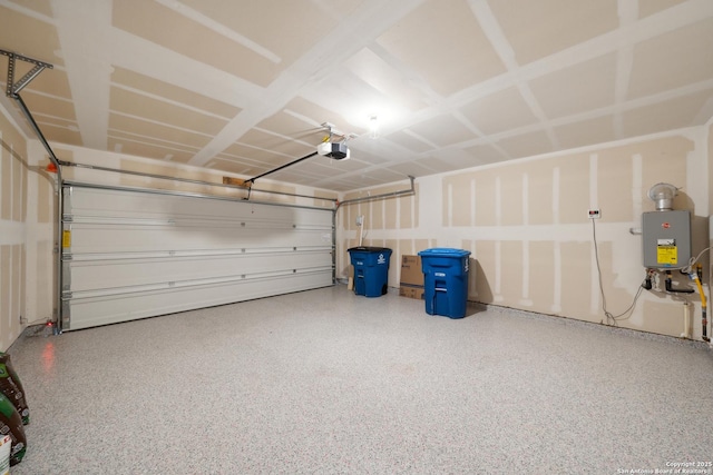 garage with a garage door opener and tankless water heater