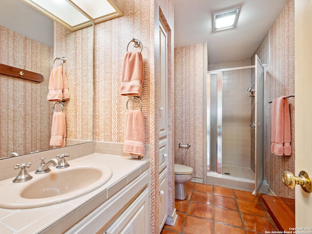 10 Parman Pl, San Antonio, TX 78230 - full bathroom featuring toilet, a stall shower, vanity, wallpapered walls, and tile patterned flooring