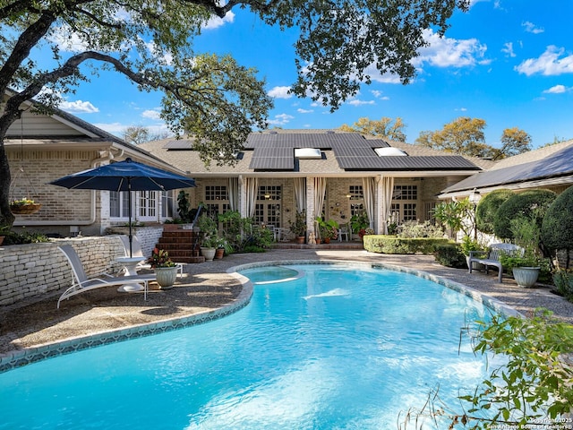 10 Parman Pl, San Antonio, TX 78230 - rear view of property with brick siding, solar panels, french doors, an outdoor pool, and a patio area