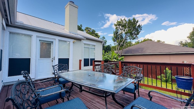 wooden terrace featuring outdoor dining area