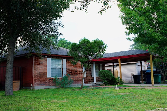 ranch-style home featuring brick siding, a front lawn, and roof with shingles