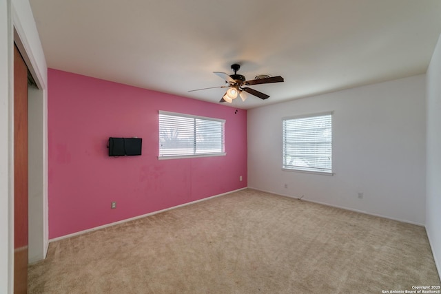 spare room featuring a ceiling fan and carpet flooring