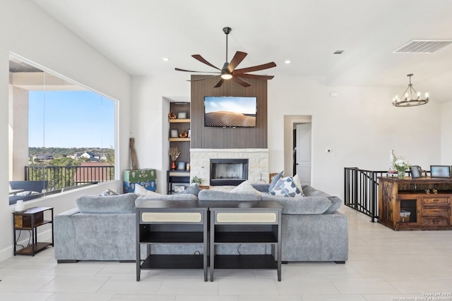 living room featuring recessed lighting, visible vents, a fireplace, and ceiling fan with notable chandelier