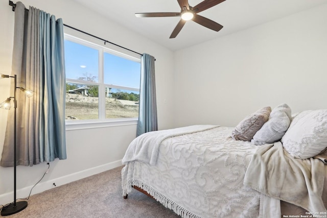 carpeted bedroom featuring ceiling fan and baseboards