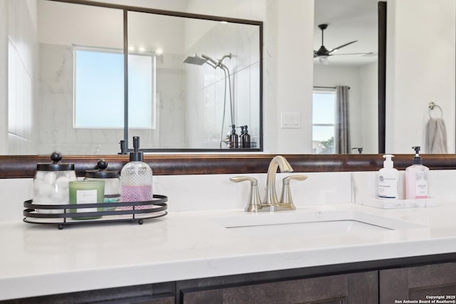 bathroom with ceiling fan, a shower, and vanity