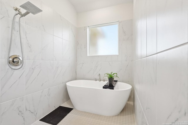 bathroom featuring a soaking tub and a tile shower