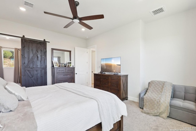 carpeted bedroom with baseboards, a barn door, visible vents, and recessed lighting