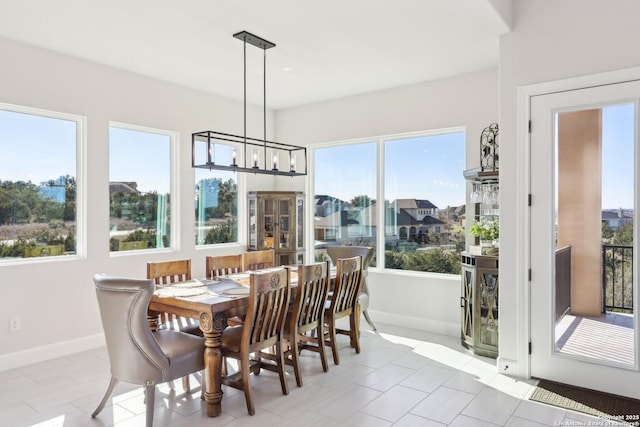 sunroom / solarium with an inviting chandelier