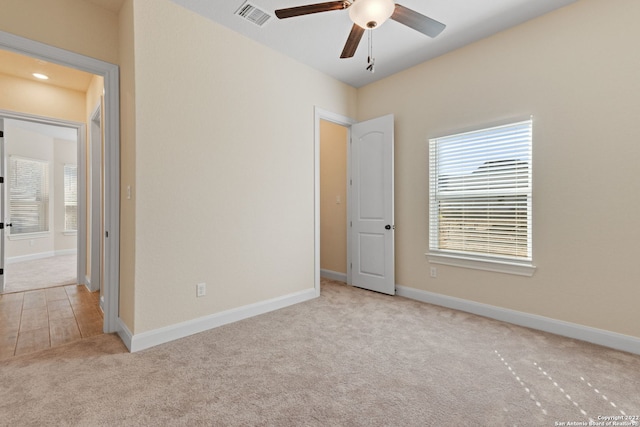 unfurnished bedroom with carpet, visible vents, ceiling fan, and baseboards