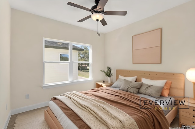 bedroom featuring ceiling fan and baseboards