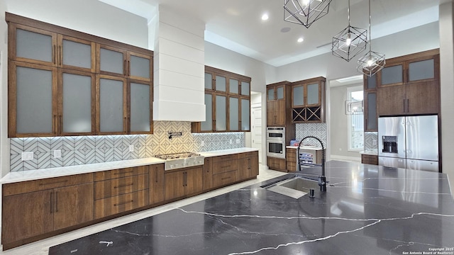 kitchen with marble finish floor, stainless steel appliances, tasteful backsplash, glass insert cabinets, and a sink