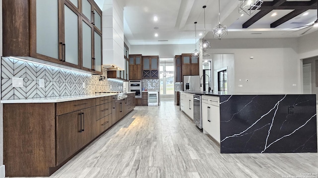 kitchen featuring stainless steel appliances, glass insert cabinets, decorative backsplash, and beam ceiling