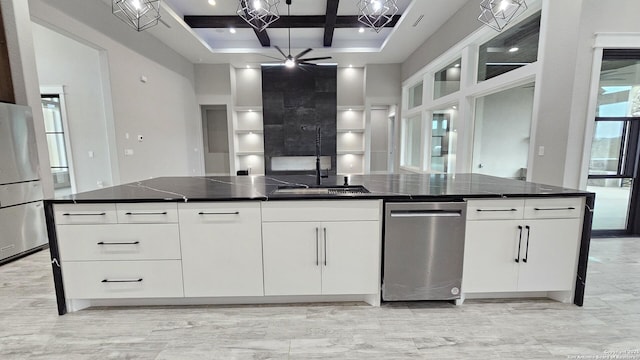 kitchen featuring white cabinets, coffered ceiling, a towering ceiling, open floor plan, and freestanding refrigerator