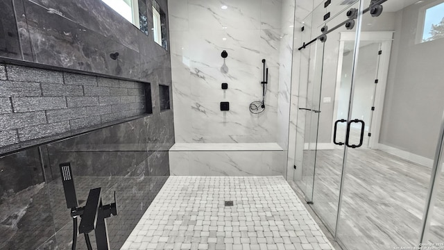 bathroom with a marble finish shower